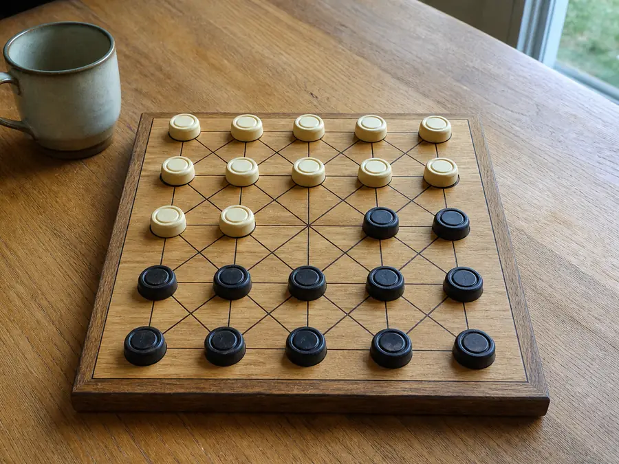 Alquerque opening: twelve pieces a side on a 5×5 lattice, centre empty